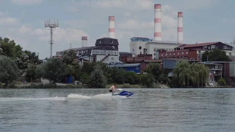 A young guy is riding a hydrocycle on the river Stock Footage 90634943