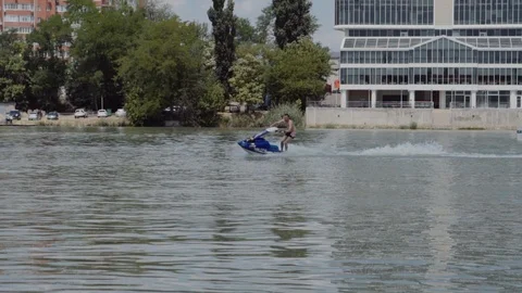A young guy is riding a hydrocycle on the river Stock Footage 90635032