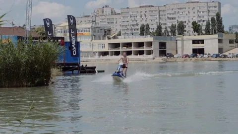 A young guy is riding a hydrocycle on the river Stock Footage 90635130