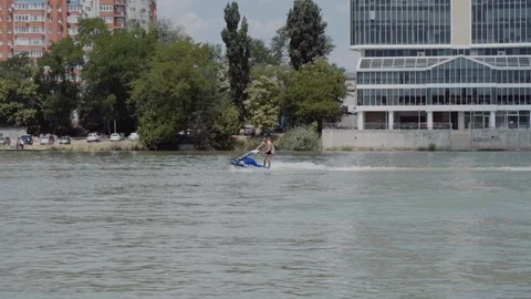 A young guy is riding a hydrocycle on the river Stock Footage 90635265