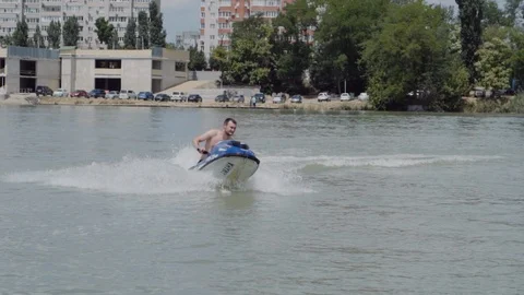 A young guy is riding a hydrocycle on the river Stock Footage 90635402