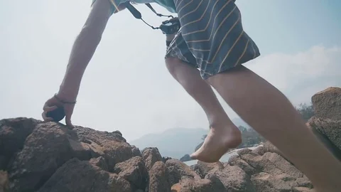 Young guy on the rock Stock Footage 73796174