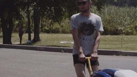 Young guy rolls on a trailer hydrocycle Stock Footage 90632267