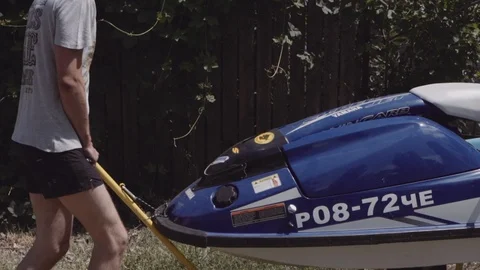 Young guy rolls on a trailer hydrocycle Stock Footage 90632608