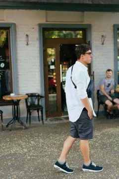 Young guy in round sunglasses posing on camera. 스톡 사진