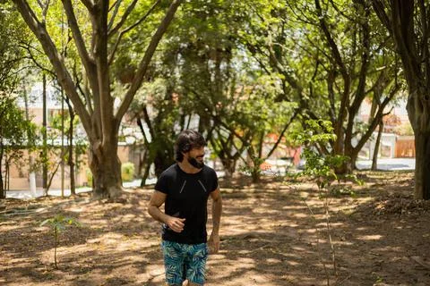 Young guy running and jogging at a park outdoors. Athlete male person during  Stock Photos