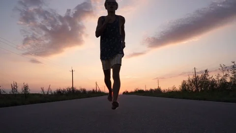 Young guy running on asphalt, sunset Stock Footage 114631449