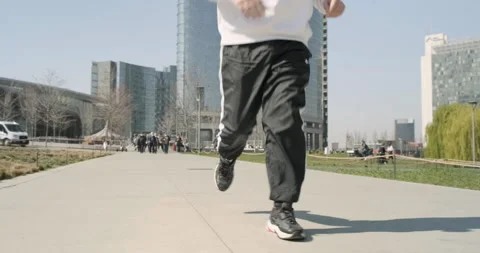 Young guy runs behind vertical forest in Milan, Italy Stock Footage 172528120