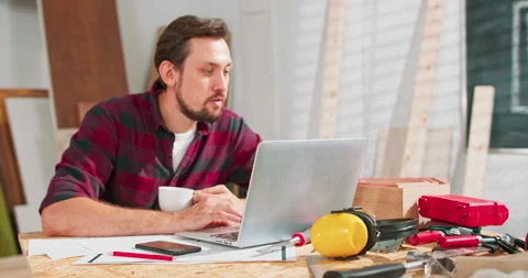 Young guy satisfied with interesting webinar on laptop computer about craft Stock Footage 144083436