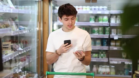 Young guy scanning qr code for cheese Stock Footage 317528016
