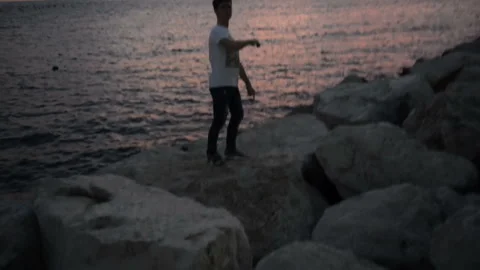 Young guy scatter and jumps from one stone to another Stock-Footage 102111395