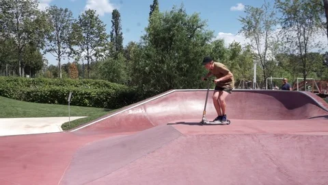 Young guy on scooter perform stunt in skatepark Stock-Footage 102249448