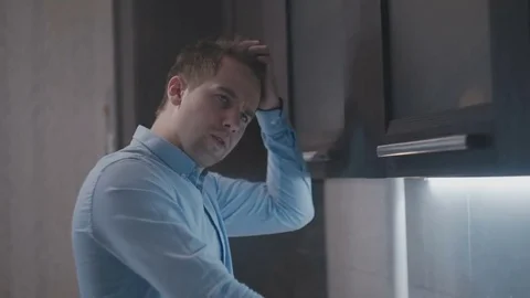 Young guy scratches his head and thinks Stock Footage 80532652