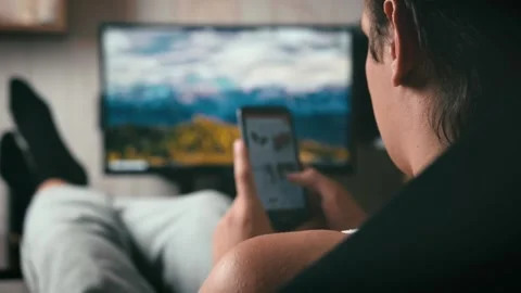 Young guy selects products in the application Stock Footage 139804188
