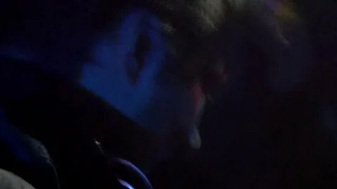 Young guy shakes his head in time with the music Stock Footage 81782871