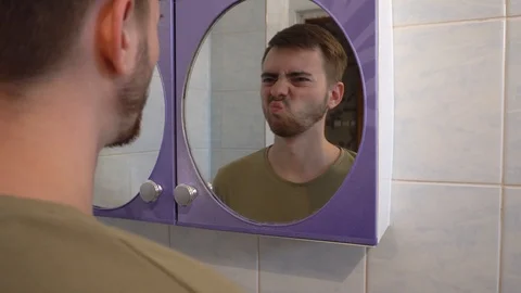 Young guy shaves his beard with a trimmer Stock Footage 114751239