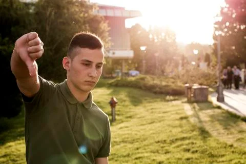 Young guy showing thumbs down sign Stock Photos