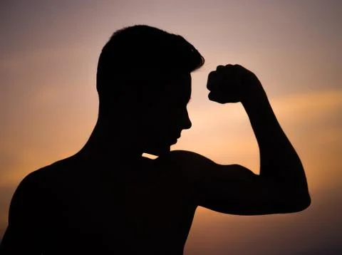 Young guy shows strength Stock Photos