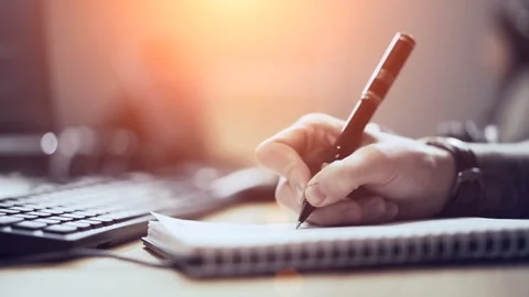 Young guy signs documents in the office. Video stock 104860648