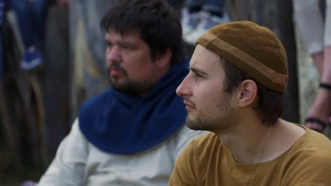 Young guy sits on the ground and look around Stock Footage 82408648
