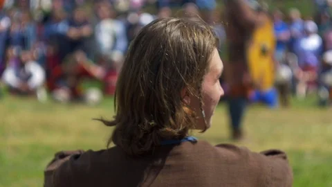 Young guy sits on the ground and looks around Stock Footage 82408744