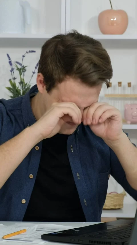 A young guy sits in the office and works on his laptop. Yawning and falling.. Stock Footage 291975470