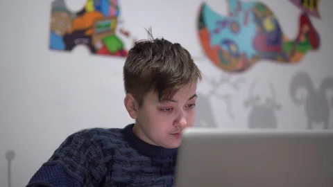 A young guy sitting at the laptop . Tired guy with red eyes works in the office Stock Footage 99005144