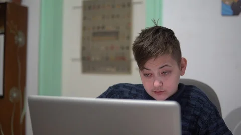 A young guy sitting at the laptop . Tired guy with red eyes works in the office Stock Footage 99005160