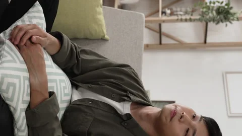 Young guy sitting on the sofa with a pillow Stock-Footage 227095982