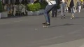 Young guy skateboarding along crowded pedestrian route, warm sunny day, slow-mo HD Footage