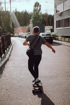 Young guy skateboarding on the street Stock Photos