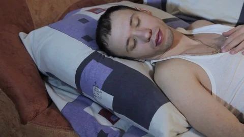 The young guy is sleeping in the bed Stock Footage 84772851
