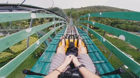 Young guy slides down the hill Stock Footage 80533633