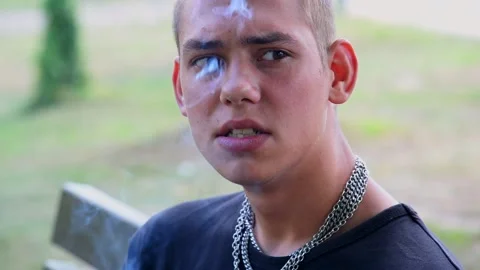A young guy smokes a cigarette Stock Footage 228665390