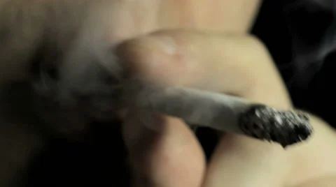 Young guy smokes a cirarette, macro Video stock 58175655