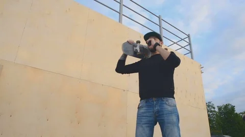 A young guy smokes standing next to the ramp Stock Footage 76617034