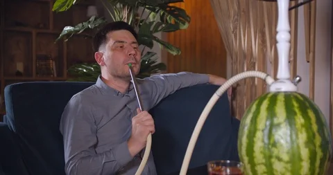 Young guy smoking hookah Stock Footage 112949489