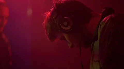 Young guy is standing over a DJ console Stock Footage 81783516