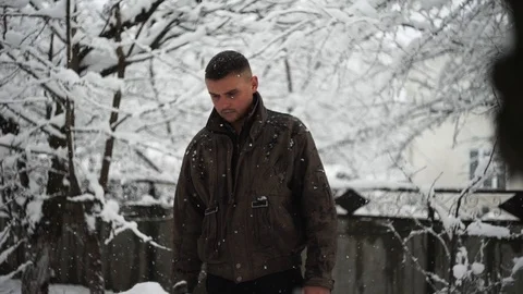 Young guy standing in the snow, head down, winter weather Stock Footage 114630945