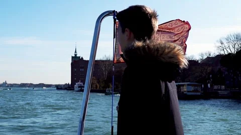 A young guy stands on the deck of a ship and looks at the horizon Video stock 262425964
