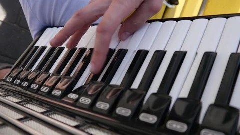 Young guy street busker playing music, accordion keys with fingers closeup Stock Footage 75303343