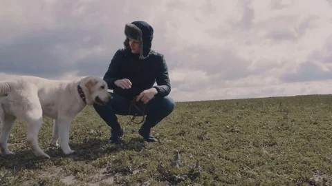 Young guy stroking his favorite dog Stock Footage 77171341