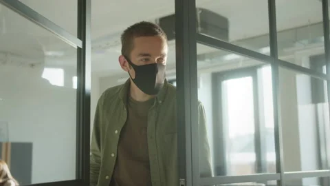 A young guy-student looks into the cabinet to his classmates and asking some Stock Footage 175403850
