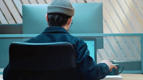 Young guy student performs the task. Your back hurts from hard work. Makes a Stock Footage 172258351