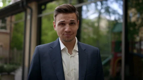 A young guy in a suit left the office and fooling around in the frame. A Video stock 134719666