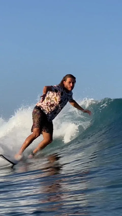 Young guy surfs in the ocean. Vertical video Stock Footage 300749868