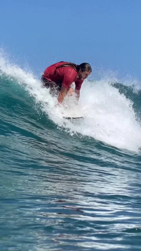 Young guy surfs in the ocean. Vertical video Stock Footage 300749870