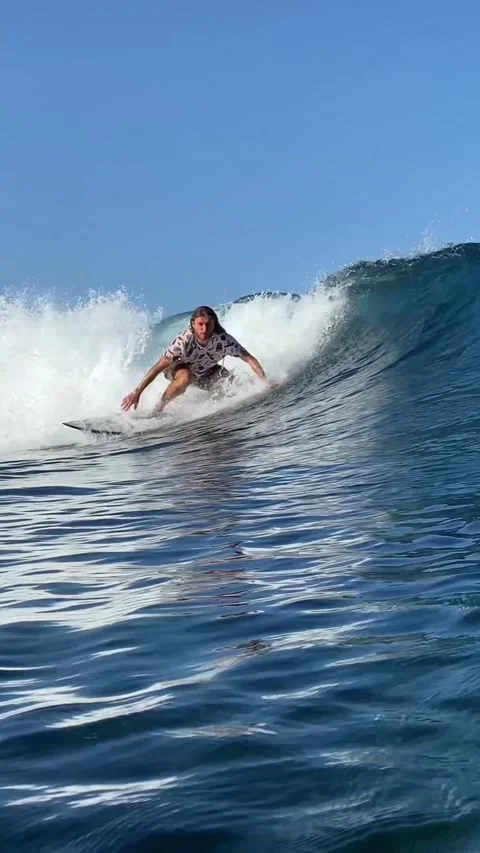 Young guy surfs in the ocean. Vertical video Stock Footage 300749878