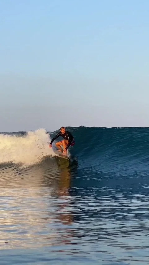 Young guy surfs in the ocean. Vertical video Stock Footage 300749886