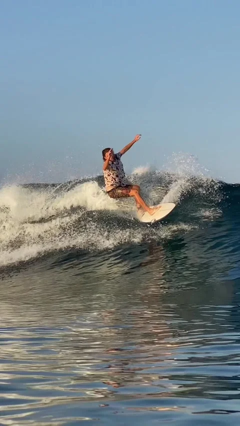 Young guy surfs in the ocean. Vertical video Stock Footage 300749904
